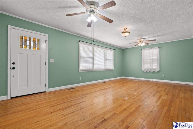 2810 Boxwood Ave, Florence, SC 29501 - entryway featuring a textured ceiling, a ceiling fan, ornamental molding, light wood-style floors, and baseboards