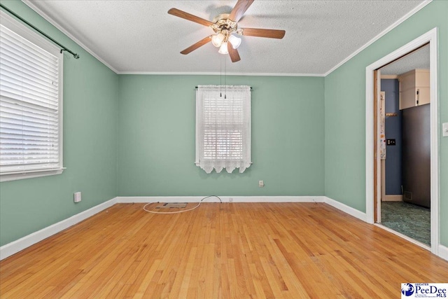 2810 Boxwood Ave, Florence, SC 29501 - unfurnished room featuring a ceiling fan, wood finished floors, healthy amount of natural light, a textured ceiling, and crown molding