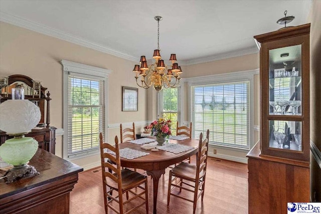 2284 Syracuse Community Rd, Darlington, SC 29532 - dining space with a chandelier, crown molding, light wood-type flooring, and wainscoting