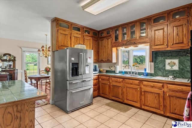 2284 Syracuse Community Rd, Darlington, SC 29532 - kitchen with stainless steel fridge, a sink, brown cabinets, and tile counters