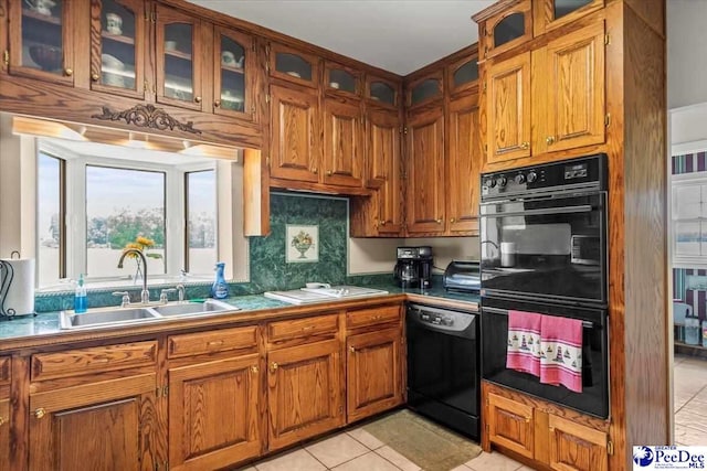 2284 Syracuse Community Rd, Darlington, SC 29532 - kitchen with black appliances, a sink, brown cabinets, and light tile patterned floors