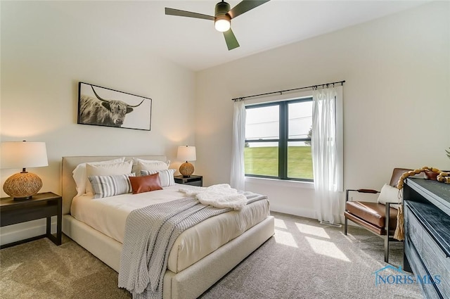 bedroom featuring ceiling fan and light carpet