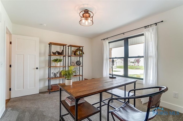 dining area featuring dark carpet