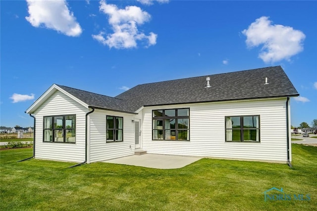 back of property featuring a patio area and a lawn