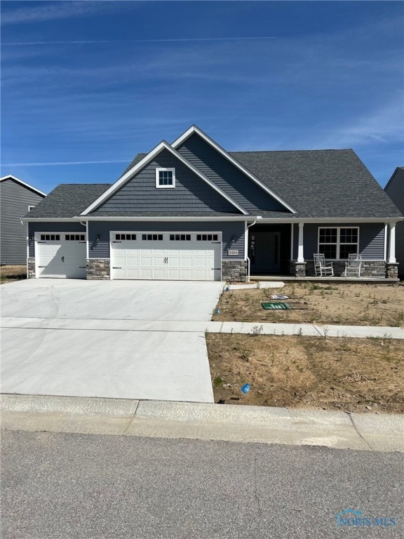 craftsman inspired home with a garage and a porch