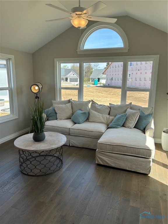 living room with vaulted ceiling, a wealth of natural light, and dark hardwood / wood-style floors