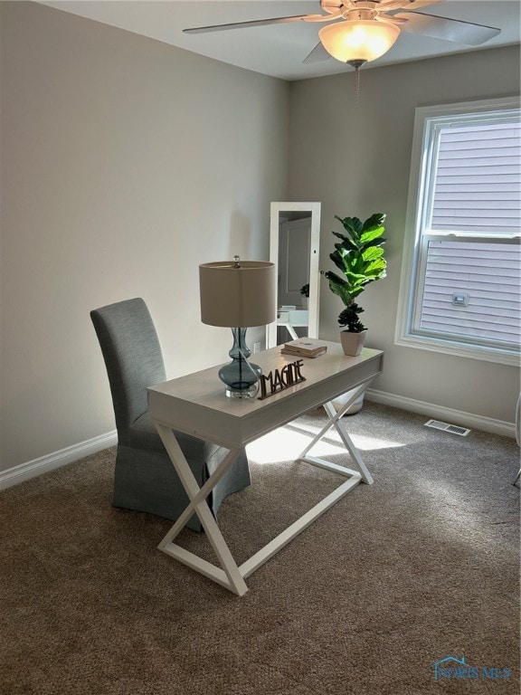 office area featuring dark colored carpet and ceiling fan