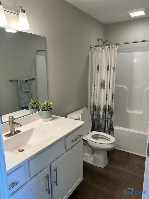 full bathroom with hardwood / wood-style flooring, toilet, oversized vanity, and shower / bath combination with curtain