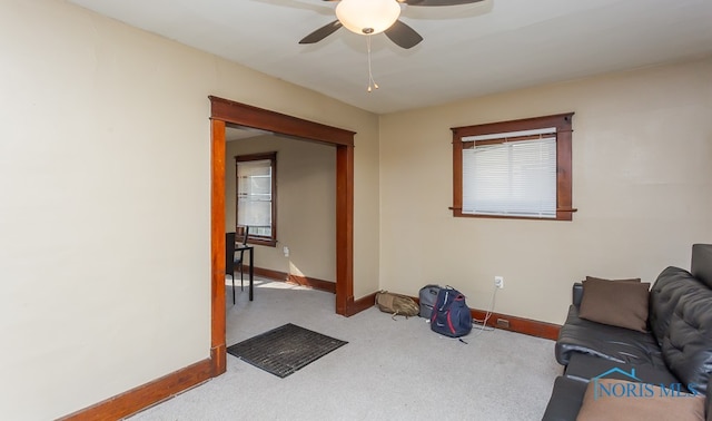 living room featuring light carpet and ceiling fan