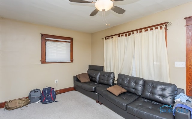 carpeted living room featuring ceiling fan