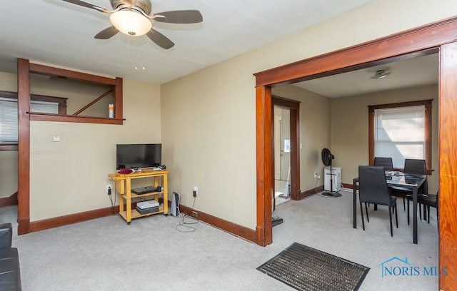 interior space featuring light colored carpet and ceiling fan