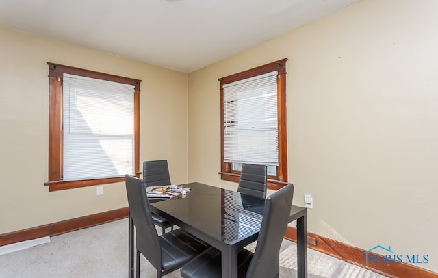 dining room with light carpet