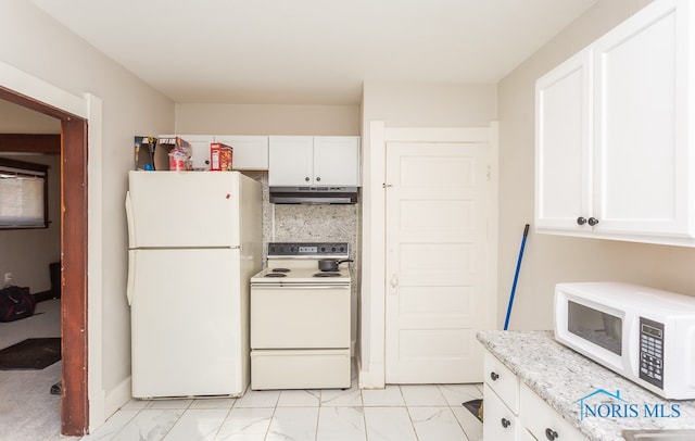 kitchen with white appliances, light stone countertops, white cabinetry, and light tile flooring