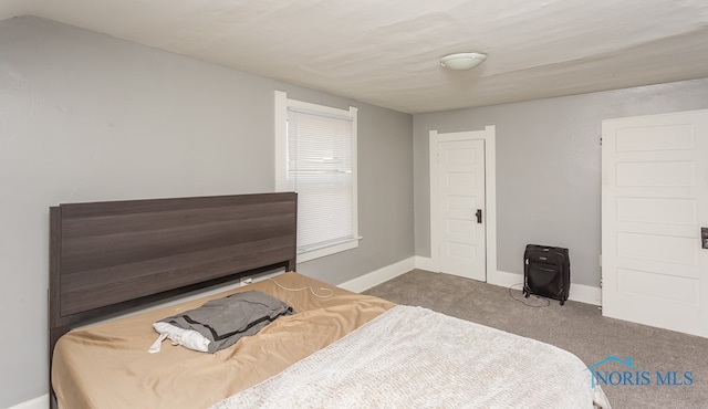 bedroom with dark colored carpet