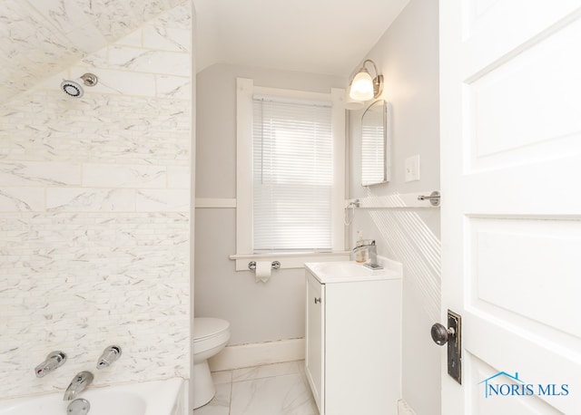 full bathroom with tiled shower / bath, toilet, tile floors, and vanity