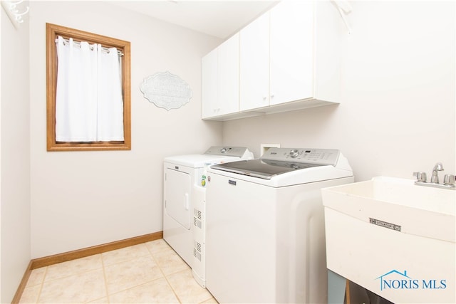 laundry room with sink, cabinets, separate washer and dryer, and light tile floors