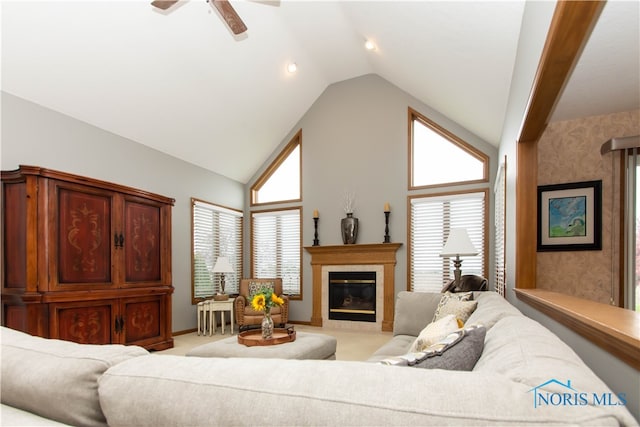 carpeted living room with ceiling fan, high vaulted ceiling, and a wealth of natural light