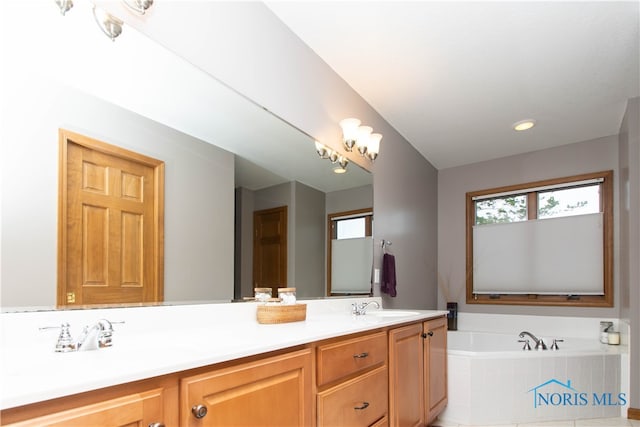 bathroom featuring dual vanity and a relaxing tiled bath