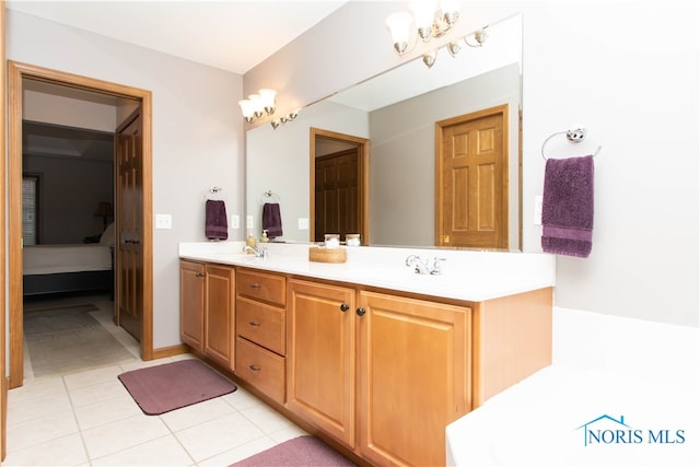 bathroom featuring double sink, vanity with extensive cabinet space, a chandelier, tile flooring, and a bath