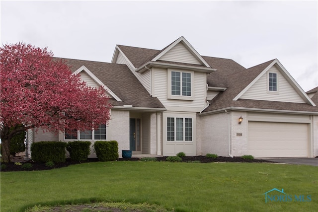 view of front facade with a front lawn and a garage