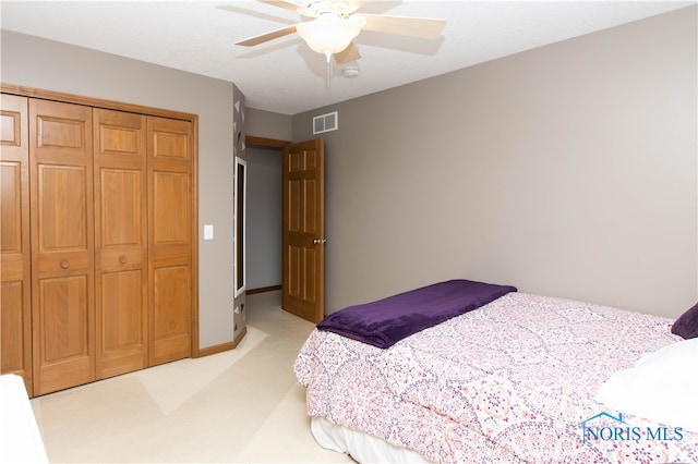 carpeted bedroom featuring a closet and ceiling fan