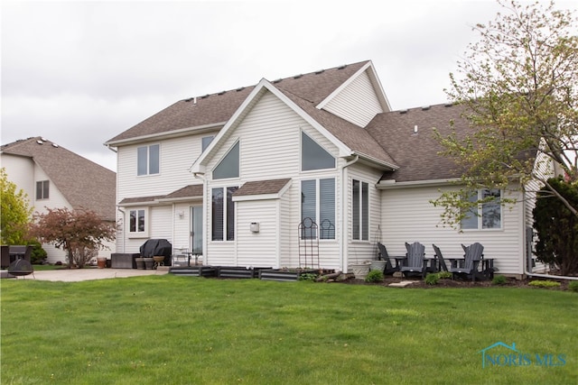 rear view of house featuring a patio and a lawn