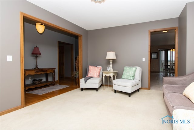 sitting room with an inviting chandelier and light tile floors