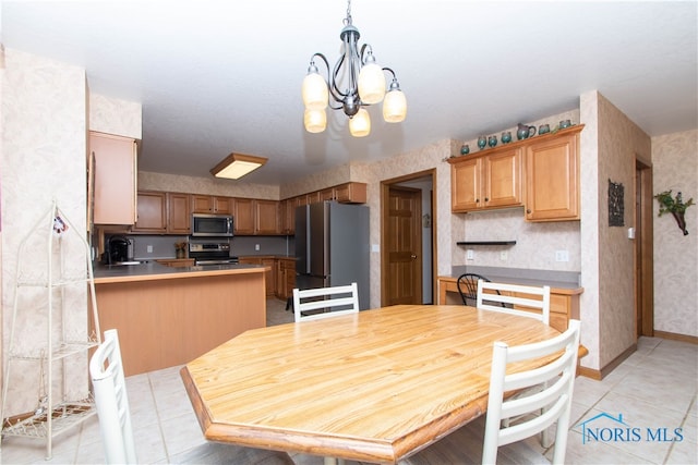 dining area featuring an inviting chandelier, sink, and light tile floors