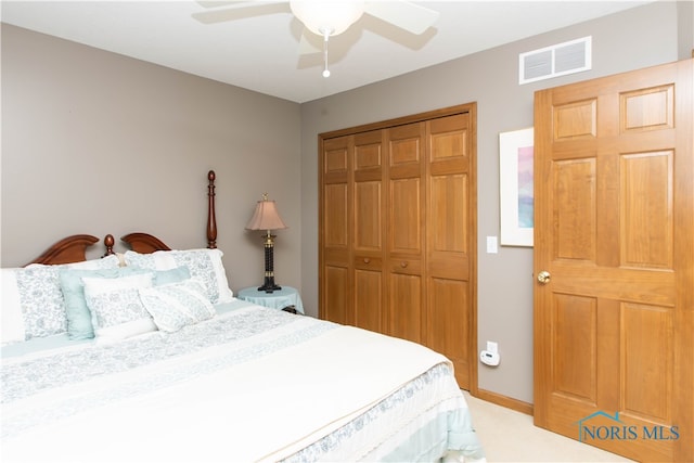 carpeted bedroom featuring ceiling fan and a closet