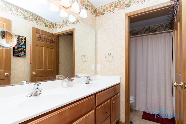 bathroom featuring double sink, tile floors, toilet, and oversized vanity