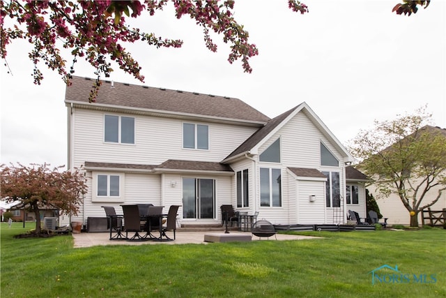 back of house with a lawn, a patio area, and central air condition unit