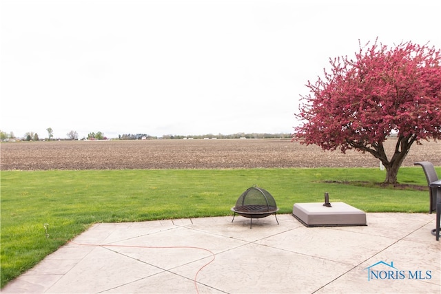 view of patio / terrace with a fire pit