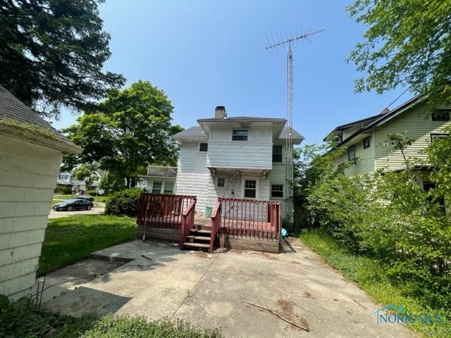 back of property with a patio and a wooden deck