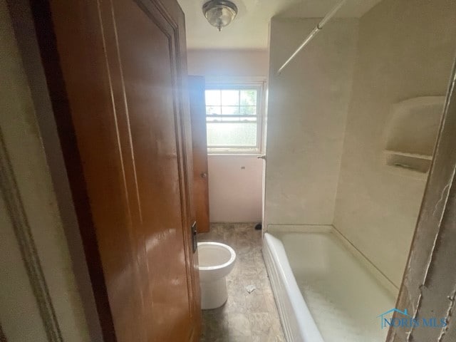 bathroom featuring tub / shower combination, tile flooring, and toilet