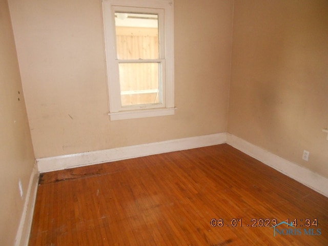 unfurnished room with hardwood / wood-style flooring