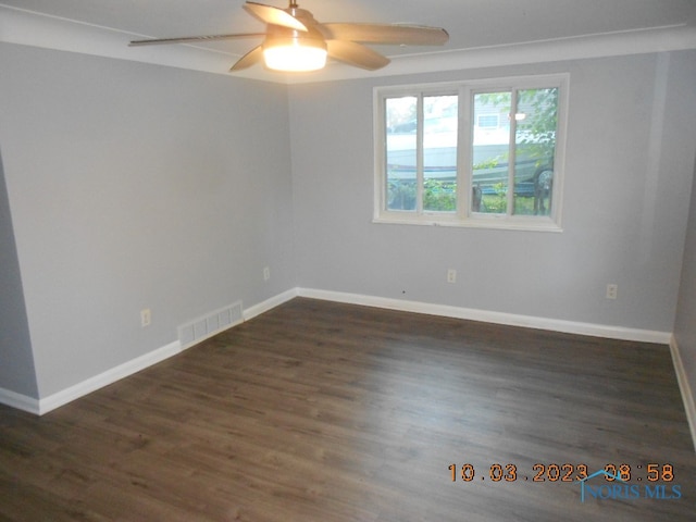 spare room featuring ceiling fan and dark hardwood / wood-style floors