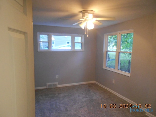 carpeted empty room with ceiling fan