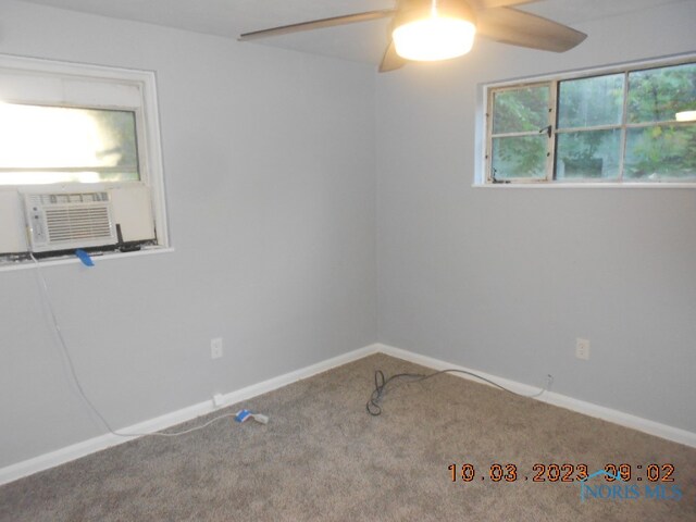 carpeted spare room with ceiling fan