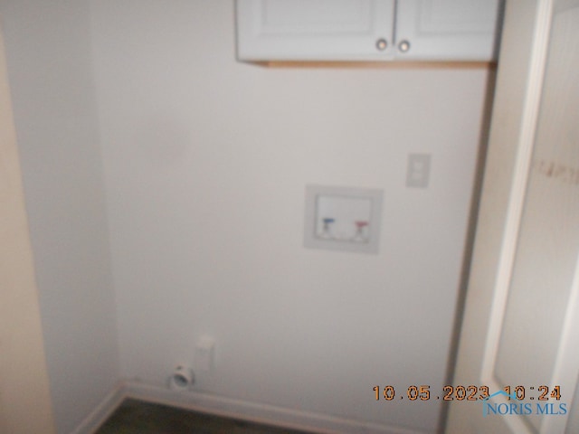 washroom with cabinets and hookup for a washing machine