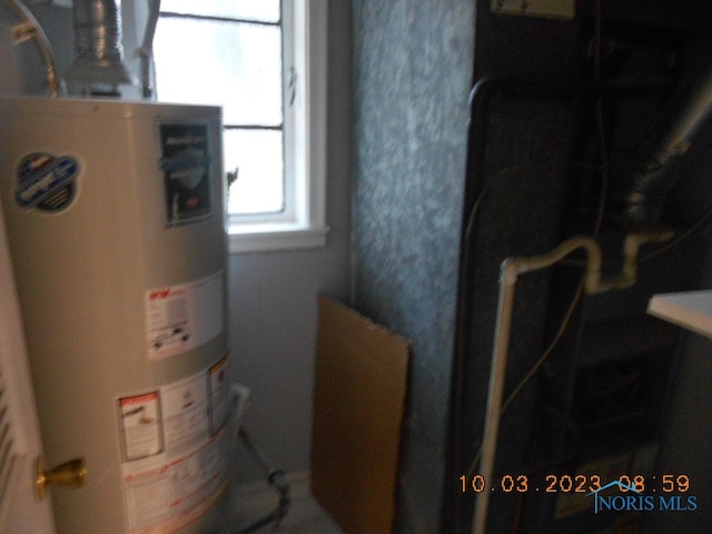 utility room featuring gas water heater