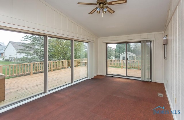 unfurnished sunroom with ceiling fan and lofted ceiling