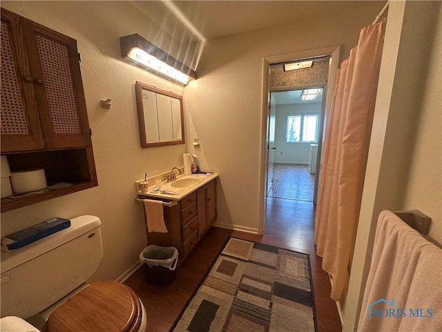 bathroom featuring hardwood / wood-style floors, vanity, and toilet