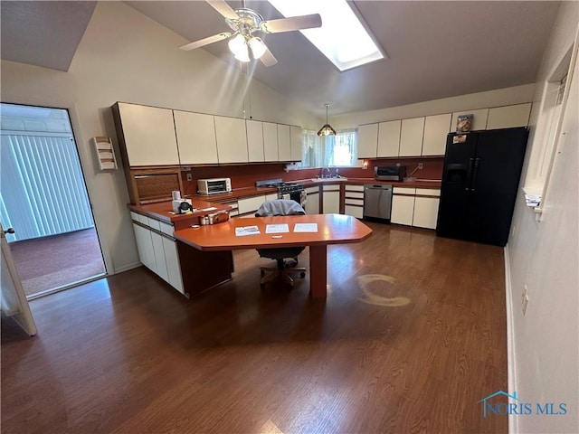 kitchen with white cabinets, appliances with stainless steel finishes, and dark wood-type flooring