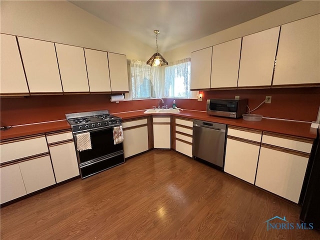 kitchen featuring white cabinets, lofted ceiling, and appliances with stainless steel finishes