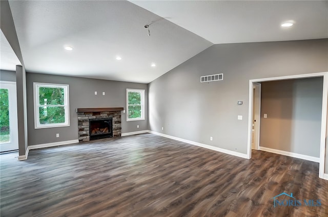 unfurnished living room featuring dark hardwood / wood-style floors, vaulted ceiling, and a fireplace