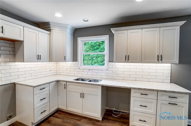 kitchen with dark hardwood / wood-style floors, tasteful backsplash, and white cabinetry