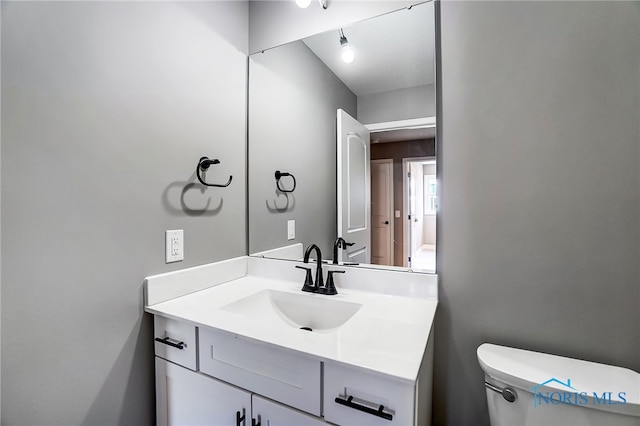 bathroom with oversized vanity and toilet