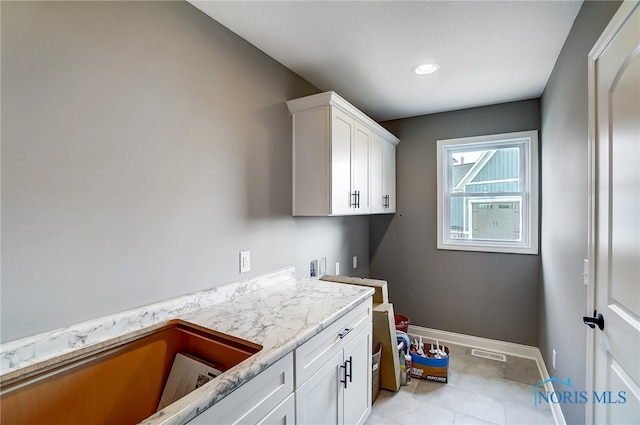 laundry room with light tile floors