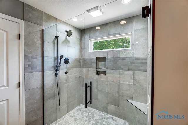 bathroom featuring a shower with door