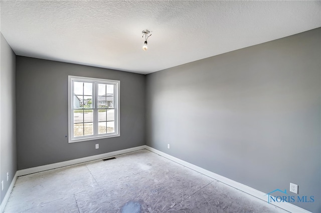 empty room with a textured ceiling